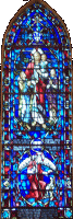 Jesus and the Little Children: This window faces west. It is located above the entrance to the narthex, by the bell tower.